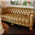 F14. Leather Chesterfield sofa. 31”h x 84”w x 37”d 